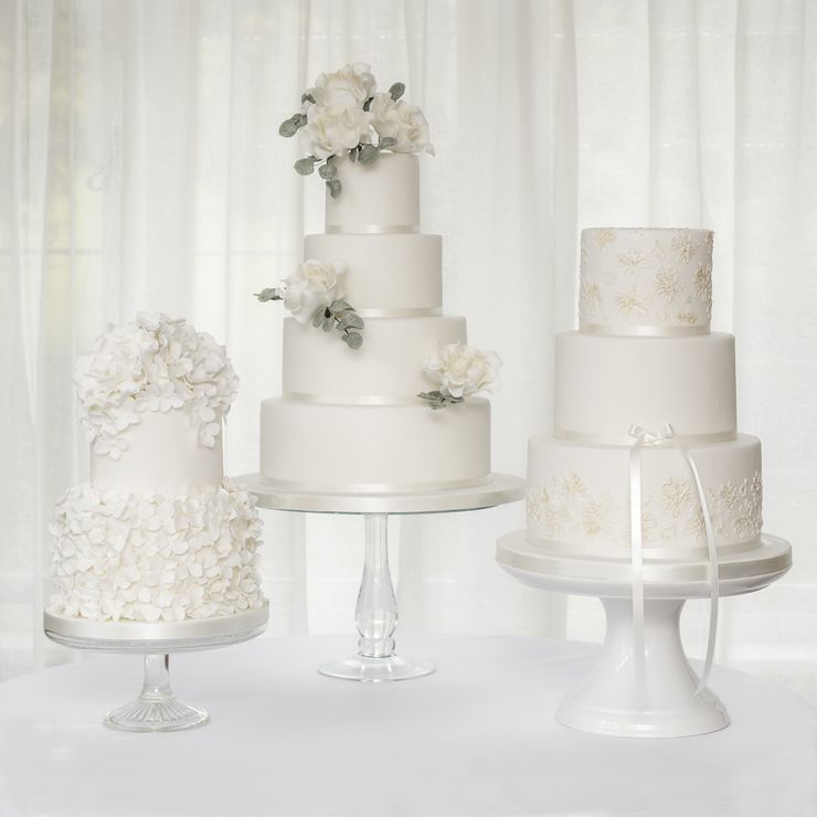 A trio of white wedding cakes