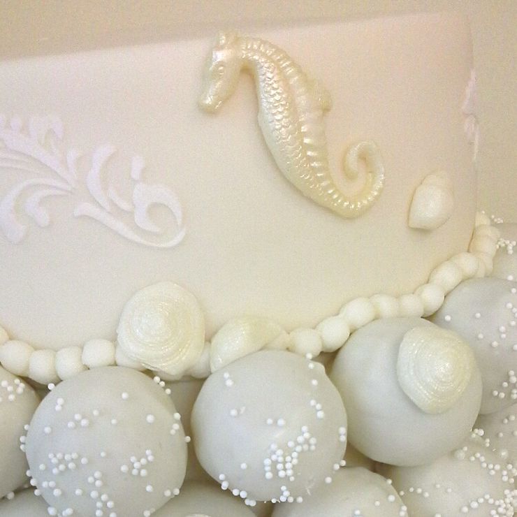 Beach themed wedding cake with cake pops
